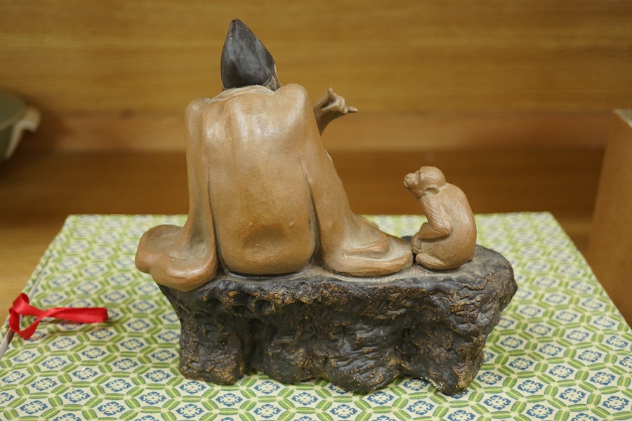 A Chinese Shiwan figure group of a luohan and monkey, housed in a fitted box, 21cm wide. Condition - good